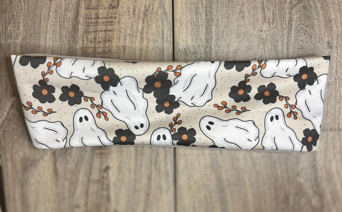 White Ghosts with black flowers on a light brown background with tan moisture wicking undereneath