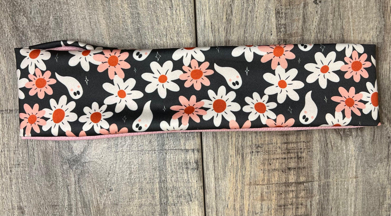 Dark background with pink and white daisy's with white ghosts scattered throughout with pink moisture wicking underneath
