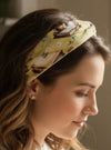 Women wearing a book print nonslip headband reading a book.