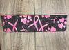 Black background with pink ribbons and hearts for breast cancer