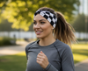 Woman seen running with black and white checkered headband on.