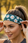 Woman wearing a floral headband outdoors with trees in the background