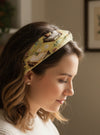 Women wearing a book print nonslip headband reading a book.
