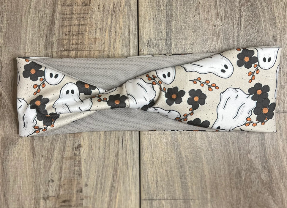 White Ghosts with black flowers on a light brown background with tan moisture wicking undereneath
