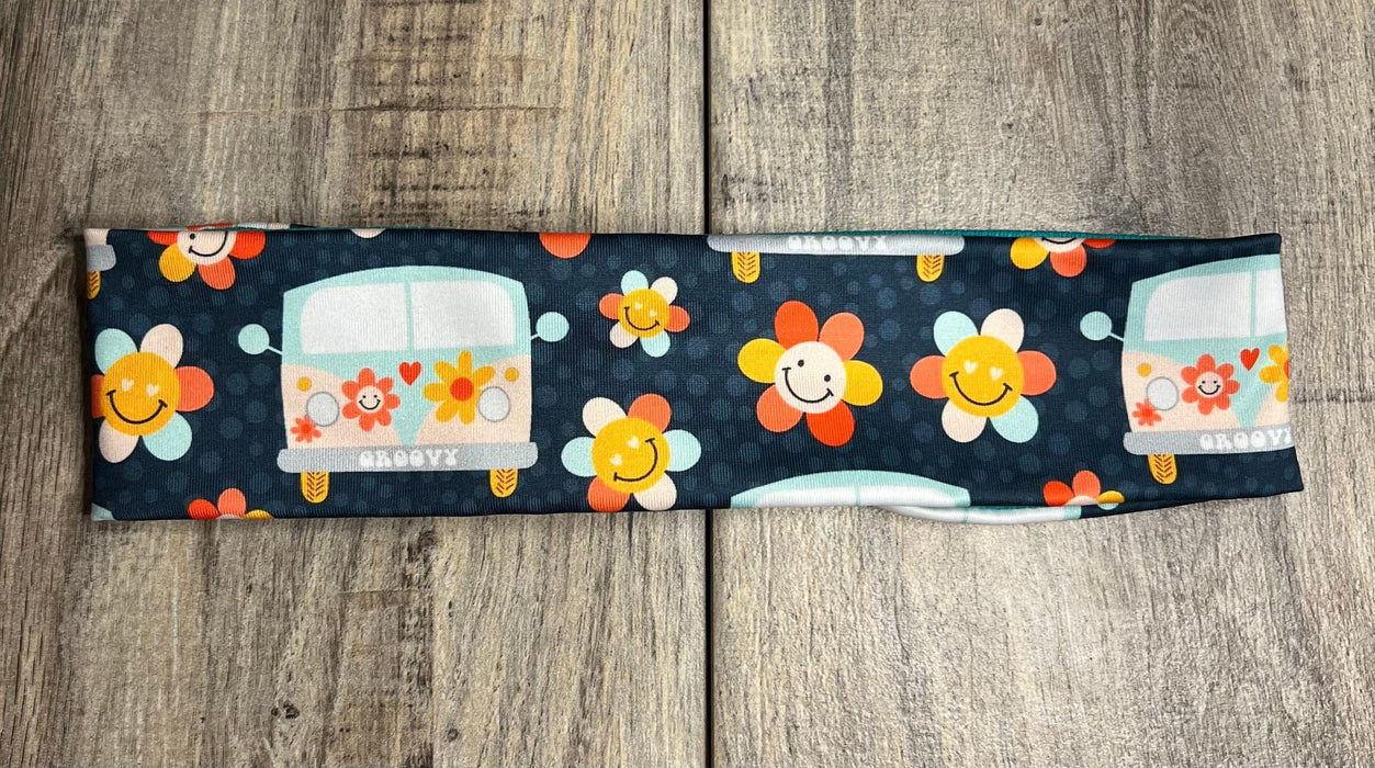 Navy background with happy daisy smiles with hippie flowers and 60s vans scattered throughout.