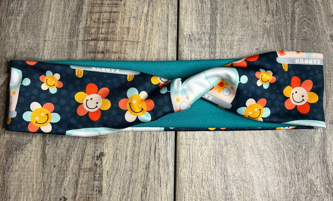 Navy background with happy daisy smiles with hippie flowers with a teal mositure wicking fabric underneath