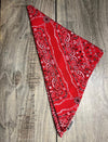 Red bandana with black patterns on a wooden surface