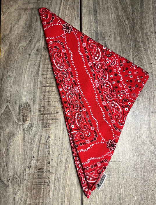Red bandana with black patterns on a wooden surface