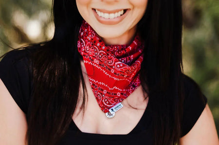 Person wearing a red bandana with a blurred natural background