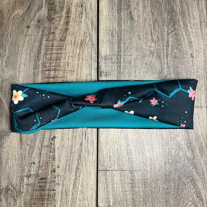 Dark Blue background with cream and pink flowers scattered throughout the serotonin molecule  with a teal moisture wicking underneath to match