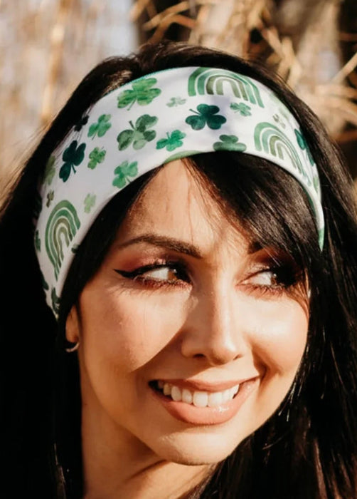 Woman wearing a green headband with shamrock and rainbow pattern