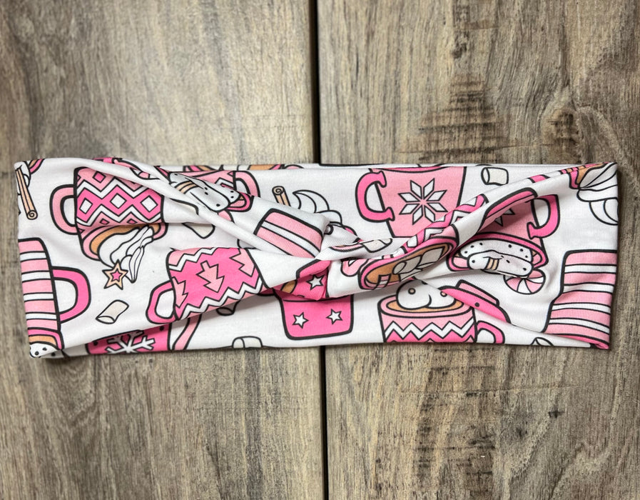 White background with pink coffee cups with snowflakes on them