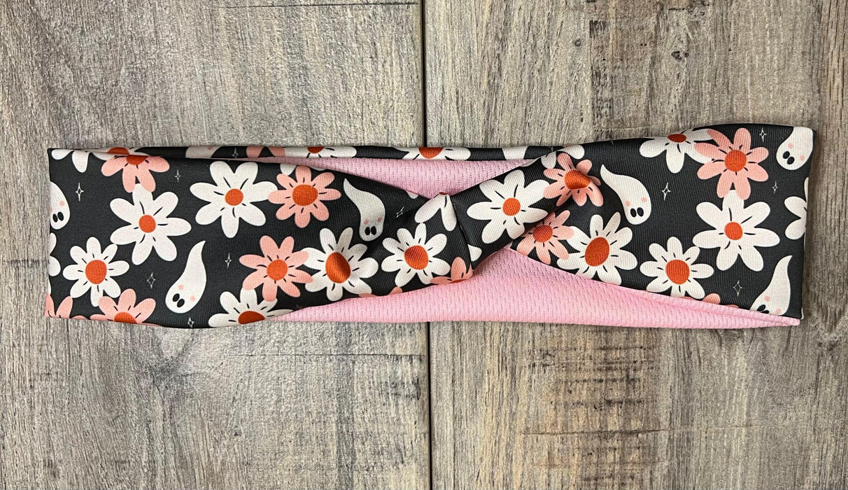 Dark background with pink and white daisy's with white ghosts scattered throughout with pink moisture wicking underneath