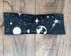 Athena Fitness celestial-themed workout headband with constellations and space designs on wooden surface