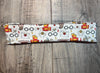 Handmade workout headband with wizard inspired glasses, scarf, key, and golden snitch design on wood background