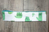 Handmade workout headband with cute green cactus-cat print on white fabric, teal inner lining