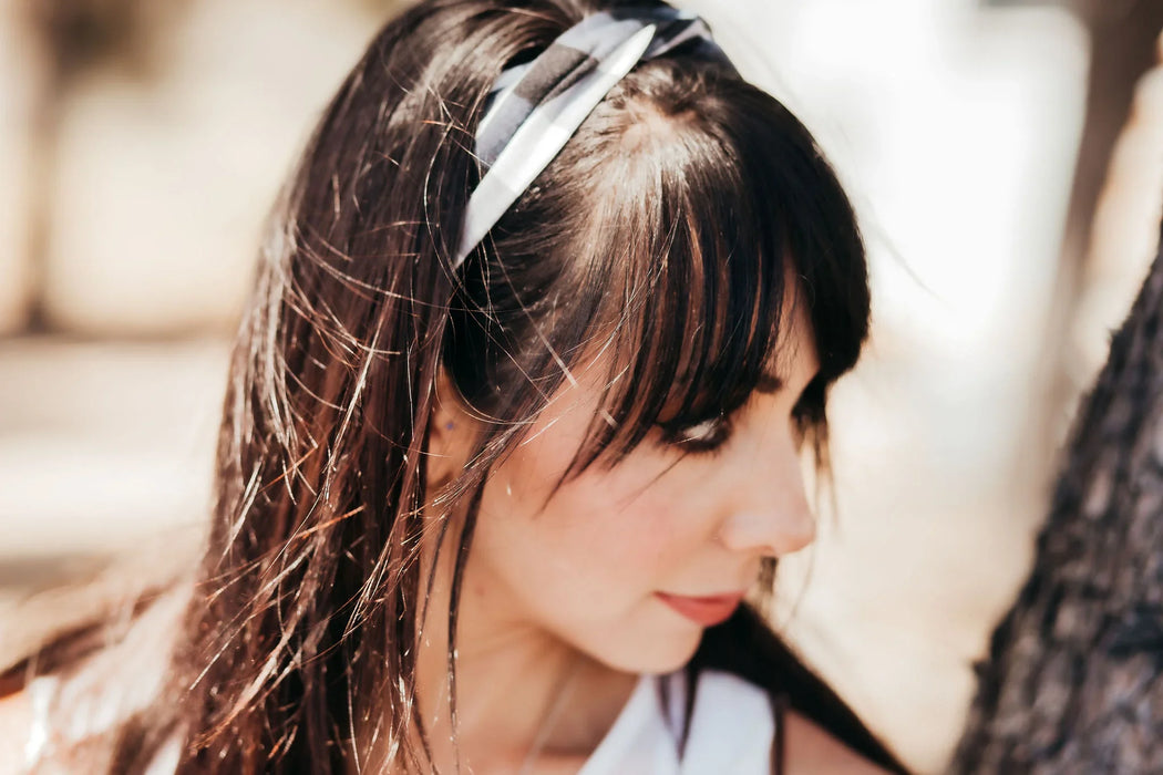Close-up of woman wearing handmade black and white workout headband 