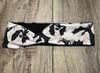 Athena Fitness handmade black and white workout headband with dragon wing pattern on wooden surface