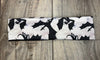 Black and white workout headband with dragon and smoke design on wooden floor