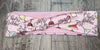 Pink workout headband with colorful cocktail glass prints and Cheers Bitches text on wooden surface