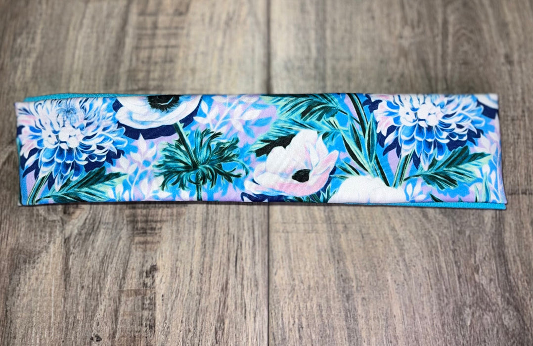Light Blue Headband with white flowers and green flora with light blue dri fit material 