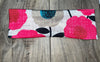 Athena Fitness floral workout headband with pink and beige flowers on wood background