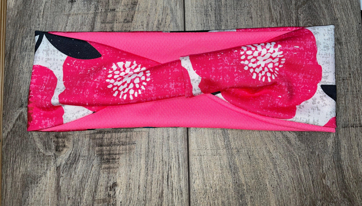 Pink and white floral workout headband with twist knot on wooden surface, Athena Fitness Collections