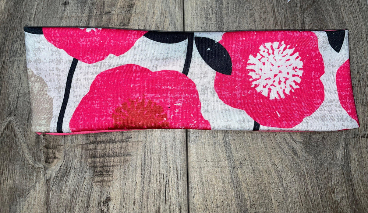 Athena Fitness Collections handmade workout headband with pink floral pattern on wooden surface