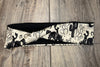 Handmade workout headband with black and white cowboy, cactus, horseshoe, and sun pattern on wood background