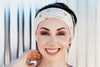 Smiling woman wearing a white sunflower print workout headband, inspired by Greek Isles