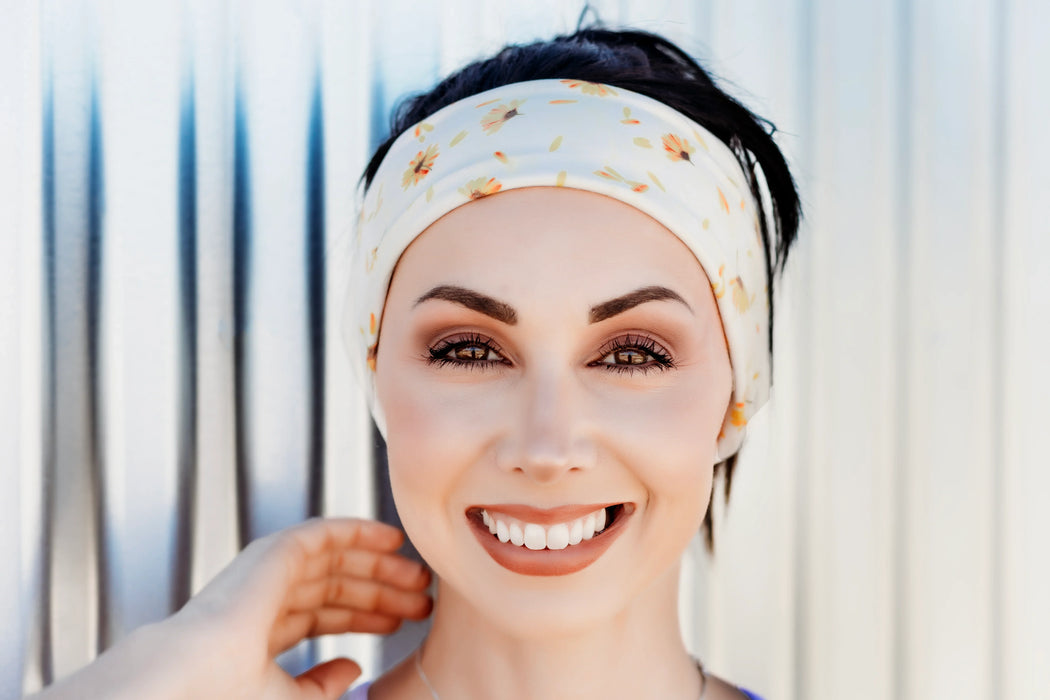 Smiling woman wearing a white sunflower print workout headband, inspired by Greek Isles