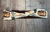 Handmade fabric vanlife workout headband with desert camper and moon pattern on wood background