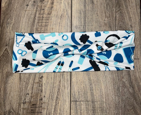 White workout headband with blue and black fitness icons pattern on wooden background