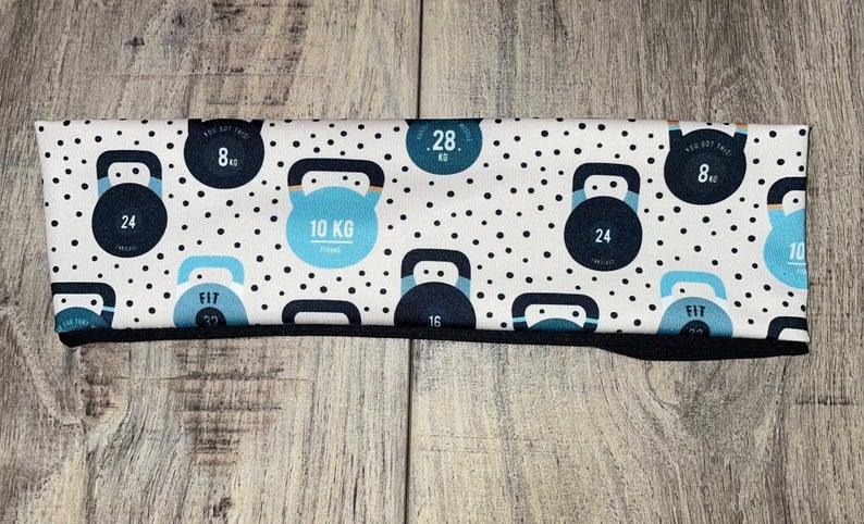 Handmade workout headband with kettlebell weight pattern in blue and black on white background